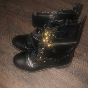 Black and gold buckled combat boots